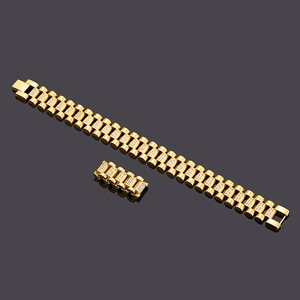 Detailed view of a gold-plated watchband style men's bracelet with inset crystals