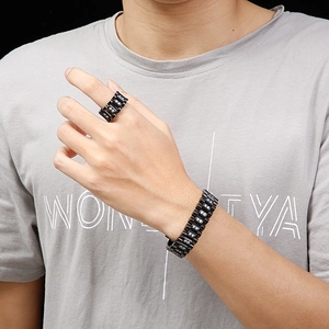 Detail of men's black stainless steel watchband style bracelet and ring set with crystals