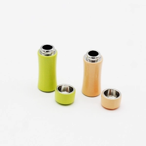 Miniature dollhouse vacuum flasks in yellow-green and beige colors with removable lids