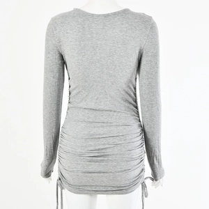 Detail of grey dress showing the ruched design and tie-back details on the back
