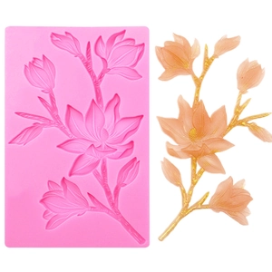 Detail of pink silicone mold with magnolia branch design and 3D floral cake decoration