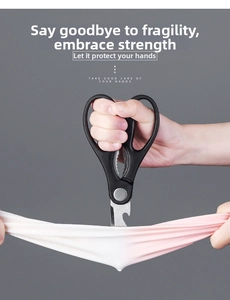Sharp stainless steel kitchen shears performing a puncture test on durable latex material
