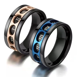Detailed view of titanium steel rings with roman numerals in black, blue and rose gold