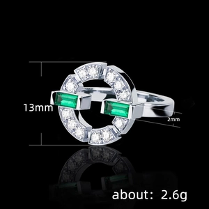 Elegant silver ring featuring emerald cut green zircons in a geometric open band design