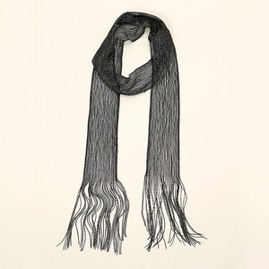 Detail of black knit scarf featuring delicate mesh texture and long fringe tassels