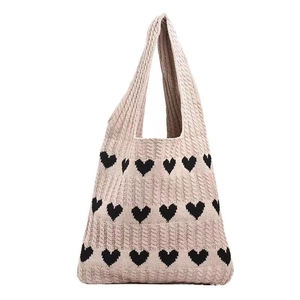 Chic cream knitted tote bag with black heart patterns and cable knit texture detailing