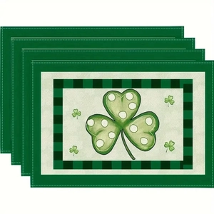 Detail of St. Patrick's Day placemats with green shamrocks and plaid border patterns