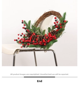 Detail of Christmas wreath with pine cones and berries on a white modern chair