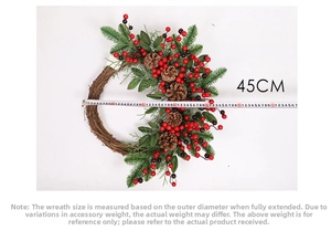 Detail view of a 45cm Christmas wreath with pine cones and berries next to a tape measure