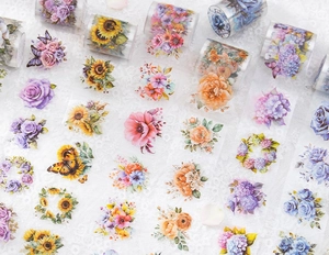Macro detail of various floral PET tapes with rose and sunflower motifs on lace