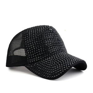 Black mesh trucker hat featuring shimmering rhinestone front panel and curved brim