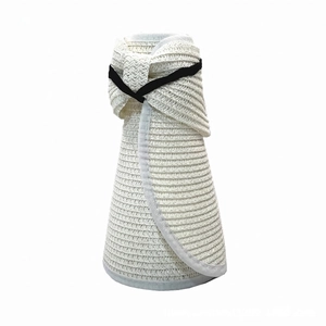 Detail of white straw sun hat featuring a black elastic band and foldable roll-up design