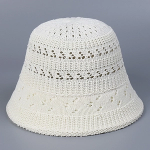 Detailed close-up of breathable hollow-out crochet texture on a beige knit bucket hat