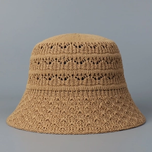 Minimalist khaki hollow out crochet knit bucket hat for women on gray background
