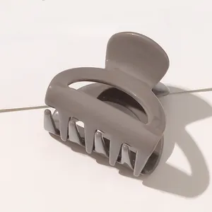 Detail of mocha brown butterfly hair claw clip with a high-gloss polished finish