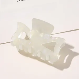Close-up of butterfly hair claw clip featuring an iridescent pearlescent finish and cutout