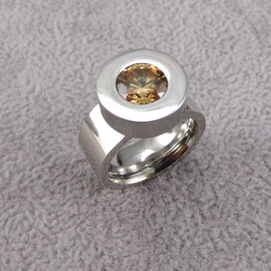 Detailed macro view of a 18K gold-plated stainless steel ring with yellow zircon bezel setting