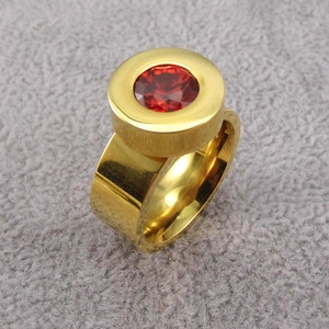 Macro shot of 18K gold plated stainless steel ring with bezel-set red zircon gemstone