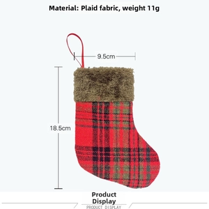 Detail of red and black plaid Christmas stocking with brown faux fur trim and hanging loop