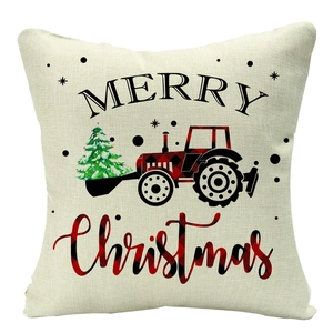 Detail of Christmas linen pillowcase showing red plaid tractor and Merry Christmas print