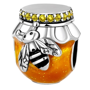 Macro detail of 925 sterling silver honey pot bead with yellow zircon and orange enamel