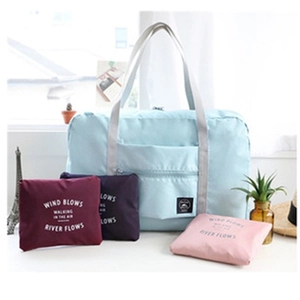 Foldable travel duffel bag shown in expanded light blue and folded multi-color states