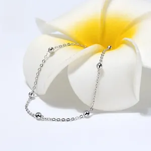Detailed macro shot of an S925 sterling silver chain bracelet with five polished beads