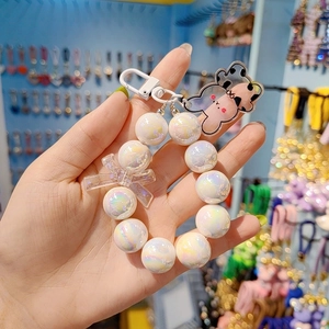 Handheld iridescent white beaded keychain with transparent bow and cute bear charm