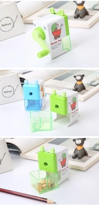 Detail of manual cartoon pencil sharpener with removable shavings tray and giraffe design