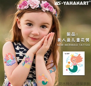 Close-up of waterproof mermaid temporary tattoo sticker W-097 on a child arm in sunlight