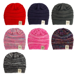 Detail showing various colors of soft knitted baby hats with MOK KIDS woven labels