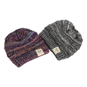 Detailed view of colorful and mixed grey knit hats for kids with MOK soft fabric labels