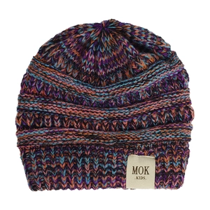 Close-up of multicolor knit texture and MOK KIDS fabric label on baby winter beanie