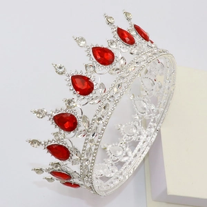 Close-up of silver bridal crown featuring red water-drop rubies and sparkling crystals