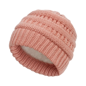 Close-up of pink knit baby hat with soft white faux fur lining for winter warmth