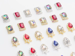 Macro detail of alloy nail art rhinestones in teardrop and octagon shapes with colorful gems