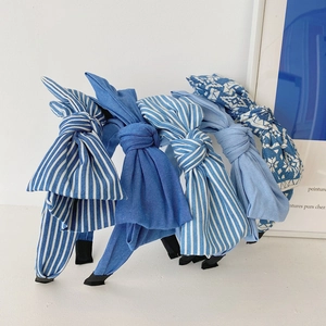 Detailed set of five blue denim fabric headbands with large bows in various patterns