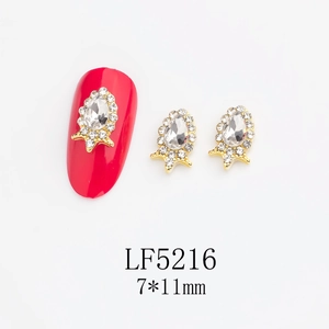 Macro view of 7x11mm teardrop nail rhinestone with starburst alloy base and gold finish