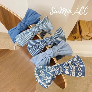 Set of five blue fabric headbands with bow details including denim and striped patterns