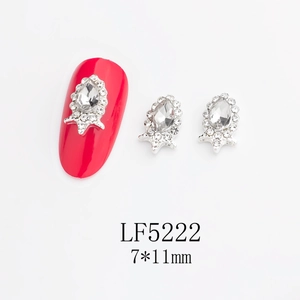 Macro shot of 7x11mm drop-shaped nail crystal with crown base and alloy accents