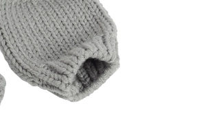 Close-up of grey chunky knit texture and ribbed cuff detail on baby winter hat