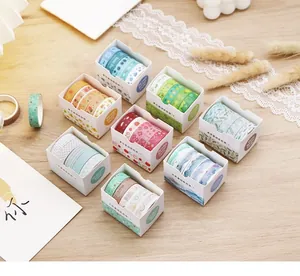 Macro shot of forest-style watercolor washi tape set on wooden table with lace decor