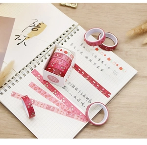 Macro detail of 5-roll watercolor washi tape set with floral and geometric retro patterns