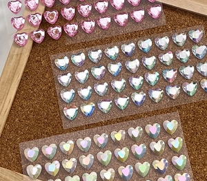Macro view of 3D heart diamond stickers in pink and crystal for kids DIY rewards