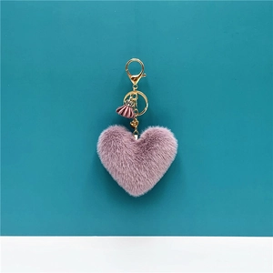 Detail of lavender heart plush keychain with gold lobster clasp and purple tassel charm