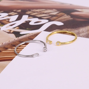 Macro shot of silver and gold rings with geometric cubic zirconia in minimalist style
