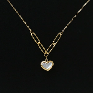 Detail of 18K gold-plated necklace featuring a white shell heart pendant on a link chain
