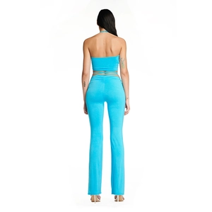 Back view of bright blue halter crop top with tie detail and flared trousers set