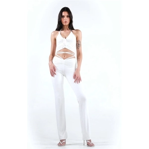 Close-up of white halter crop top and high-waisted trousers set in soft stretchy fabric