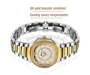 Detailed view of the diamond bezel oval watch with gold and silver link bracelet